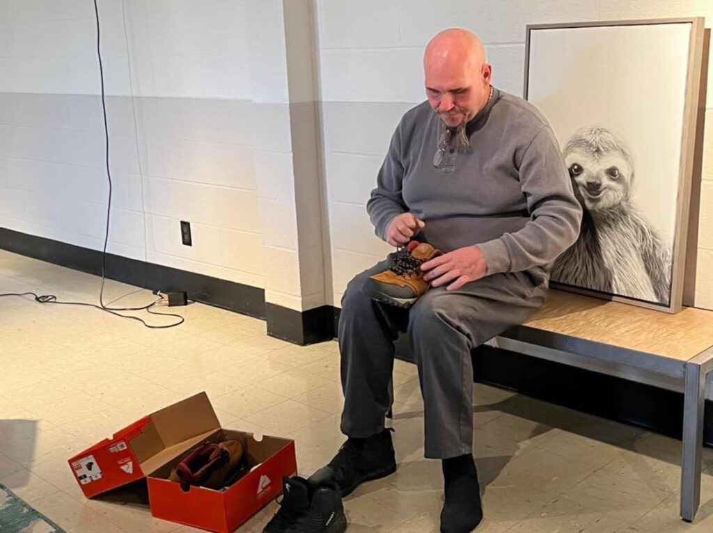 ComFe Guest putting the new pair of shoes he'd just received.