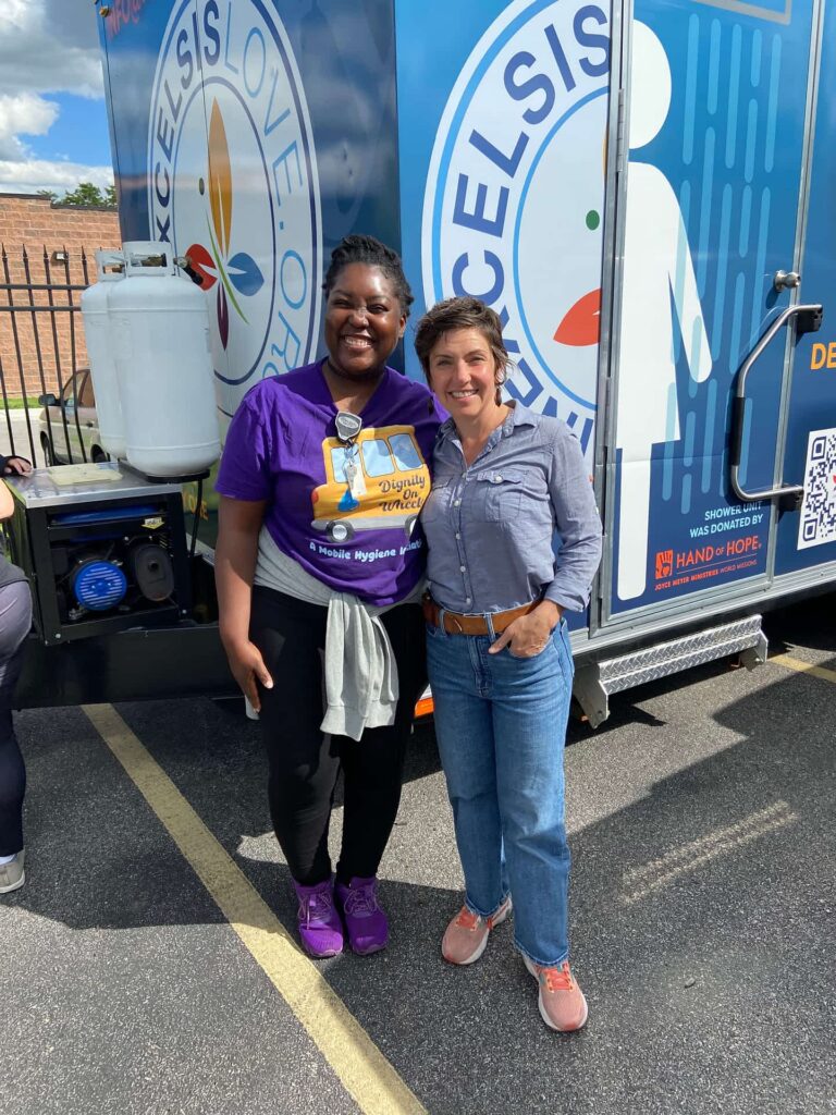 Dignity on Wheels (DoW), mobile shower initiative manager with Cara Spenser, St. Louis mayor touring the mobile shower trailer during the tornado relief efforts.