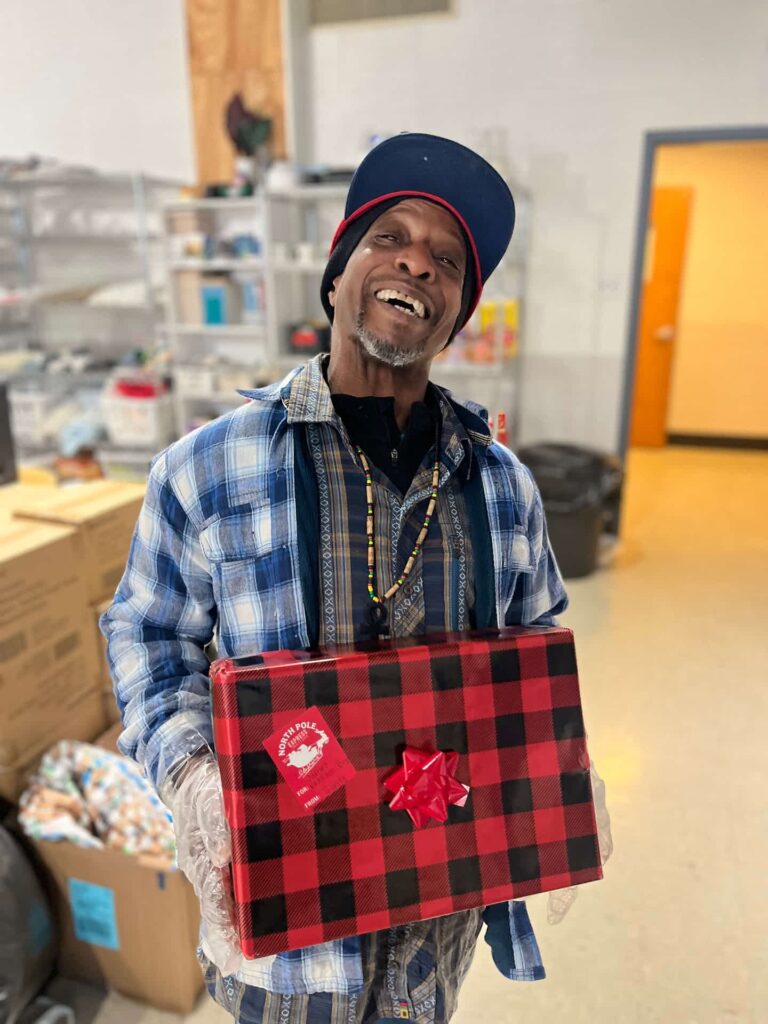 ComFe Guest happy to receive a Christmas present at ComFe.