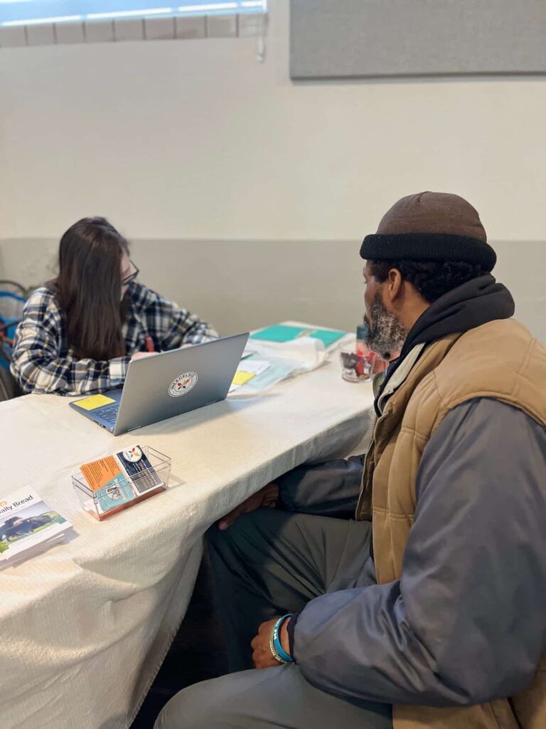 ComFe Guest getting connected to essential services at the "Resource Table"