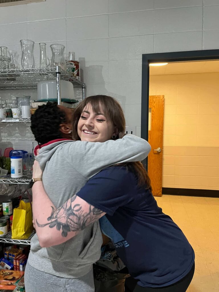 ComFe Our team leader Diana hugging a guest.