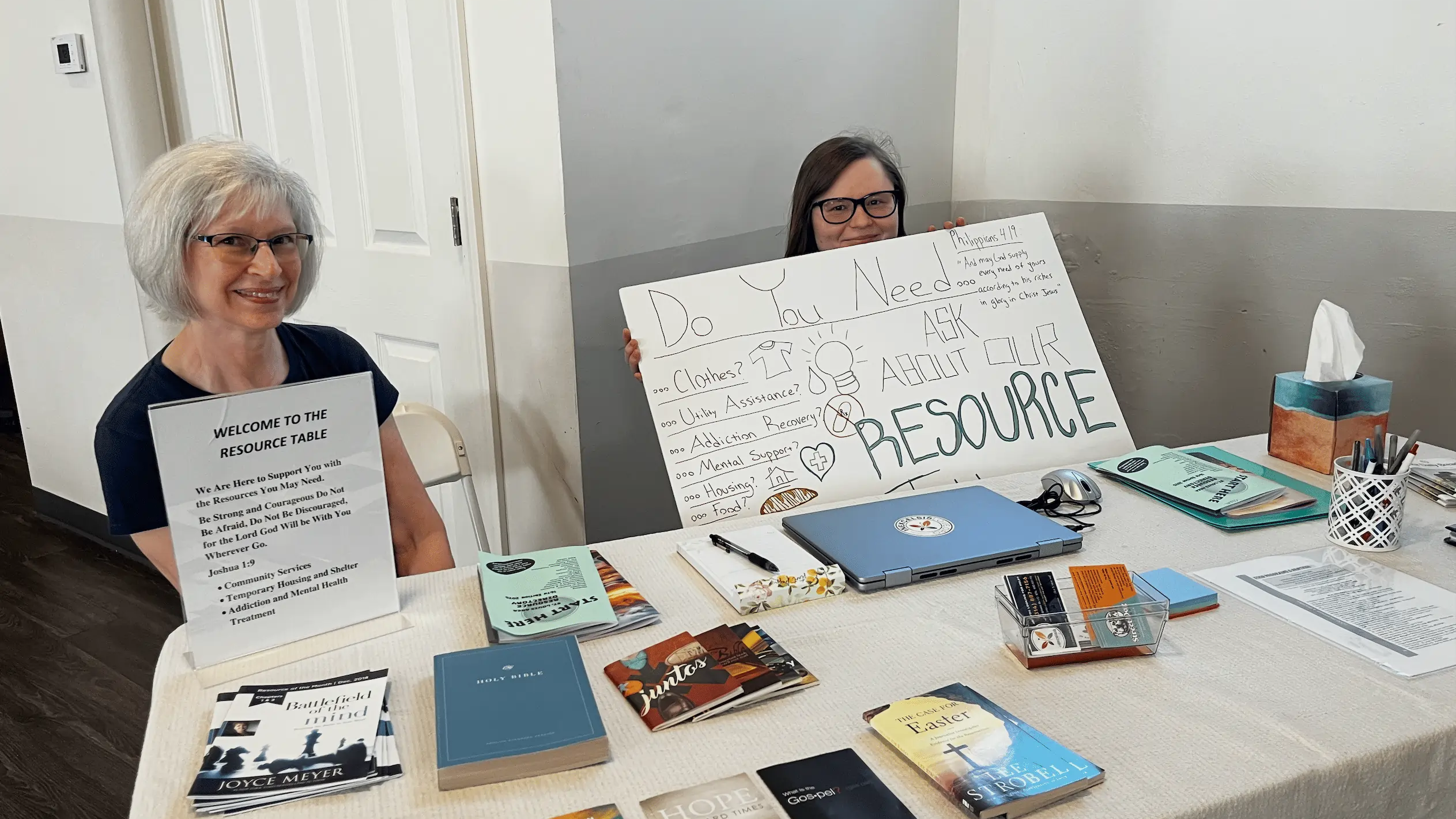 Michelle and Tobi at the resource table welcoming guest in need of guidance and referral.l