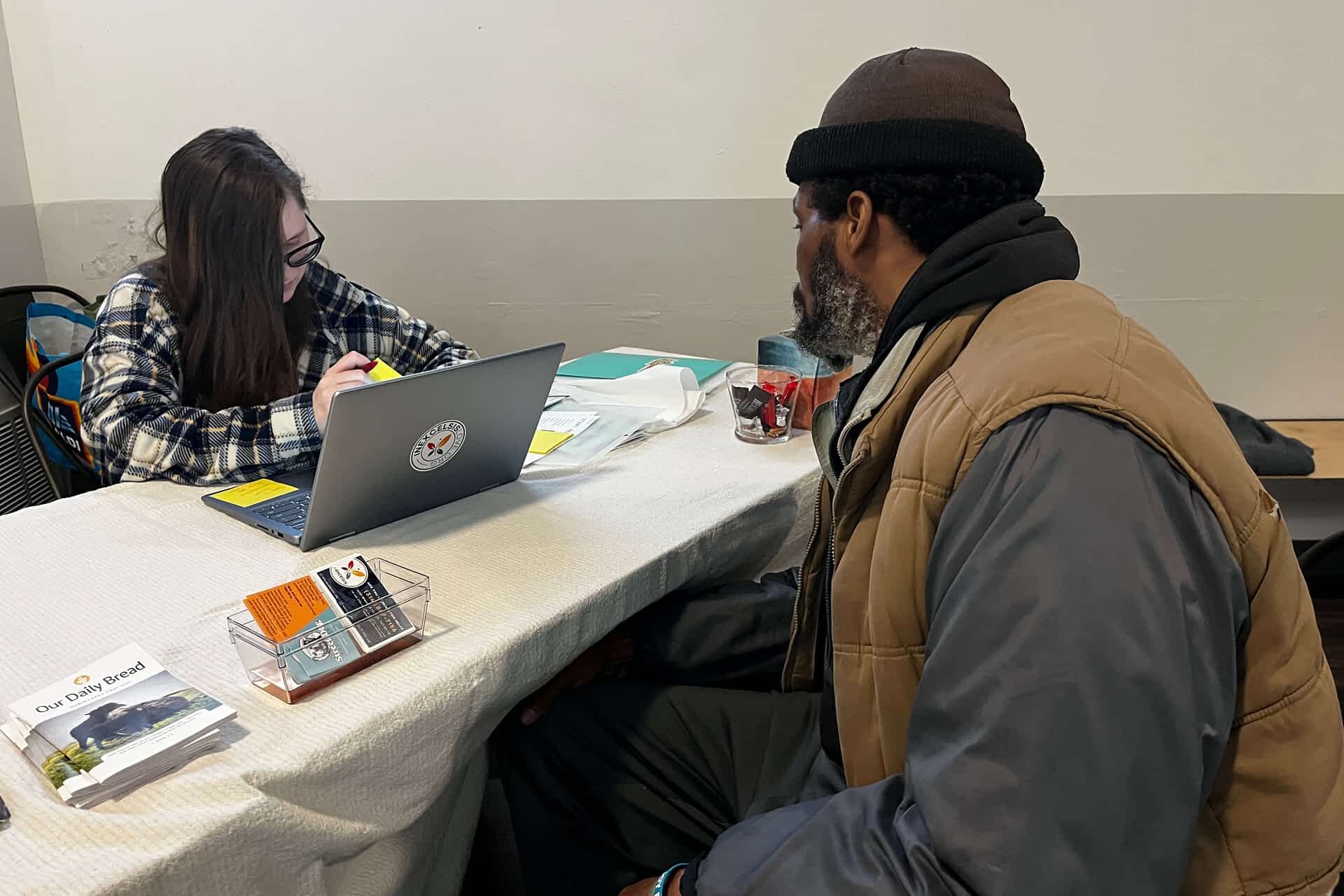 a guest being assisted in filing for his essential documents at the resource hub-ComFe-2025