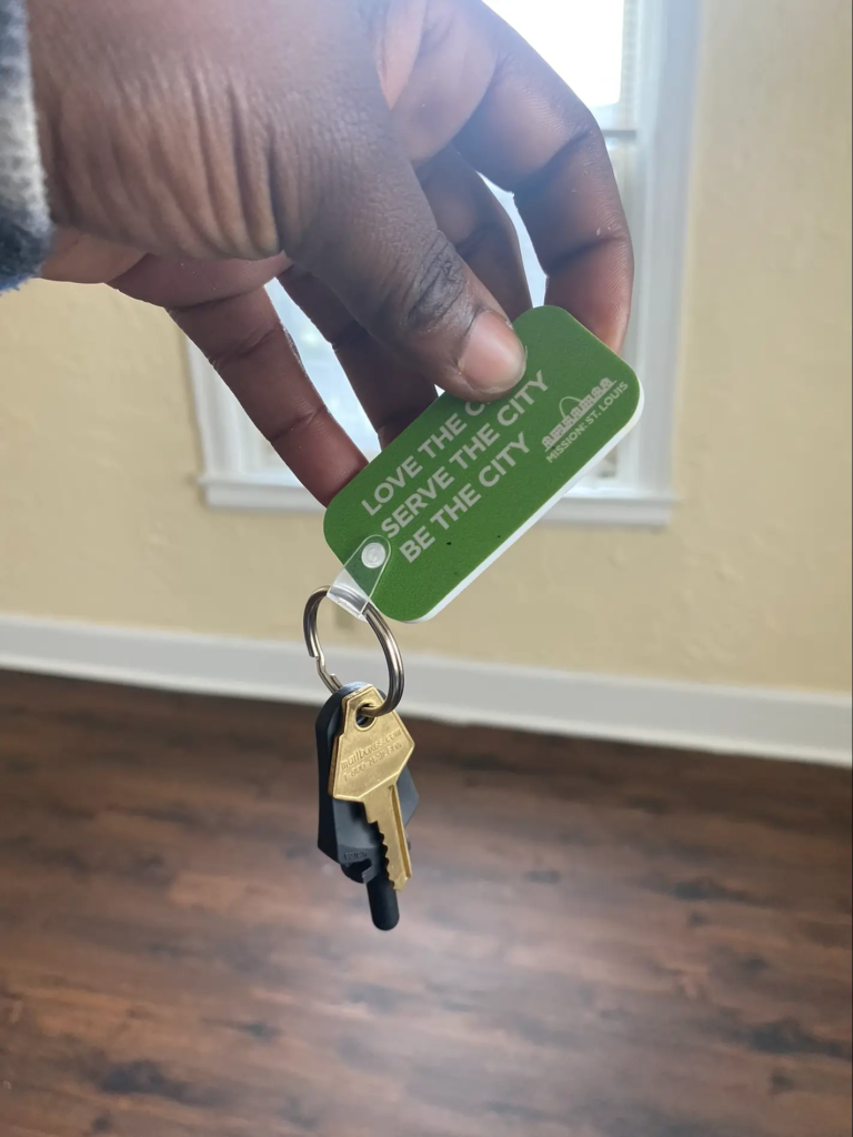 A guest holding the key to her new apartment.